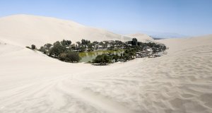 Village around lake surrounded by sand dunes