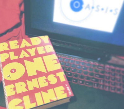 Ready Player One by Ernest Cline on the keyboard of a laptop showing the OASIS logo