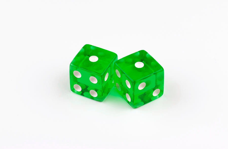 Pair of translucent green dice with white pips showing 1