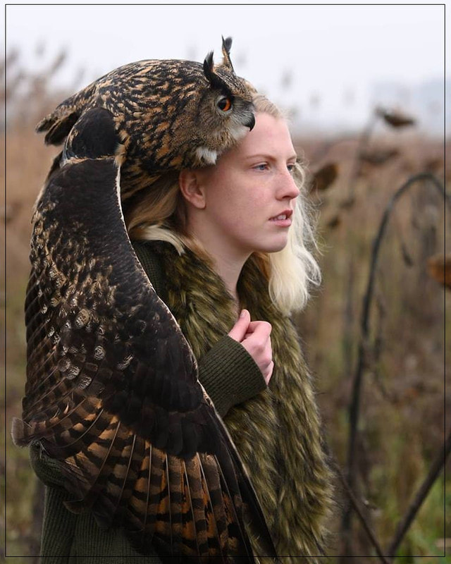 Woman with owl on her shoulder