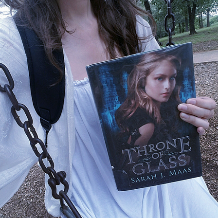Sitting on swing, holding Throne of Glass book