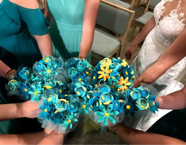 Bouquets of teal and yellow paper flowers