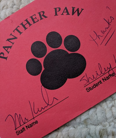 Black panther paw on red paper